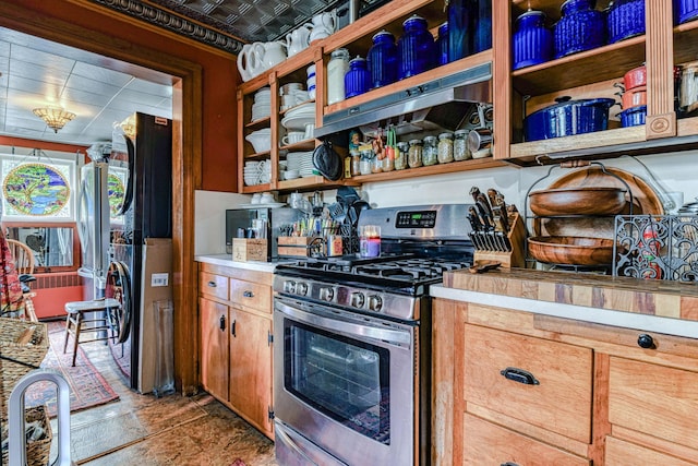 kitchen featuring stainless steel range with gas cooktop, light countertops, and open shelves