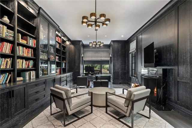 living area with built in features and an inviting chandelier