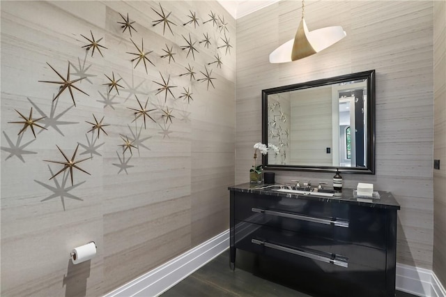 bathroom with hardwood / wood-style flooring, vanity, and wood walls