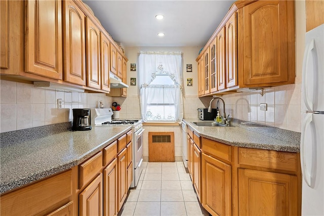 kitchen with sink, light tile patterned floors, and white appliances