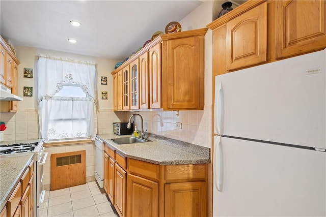 kitchen with decorative backsplash, white appliances, sink, and light tile patterned floors