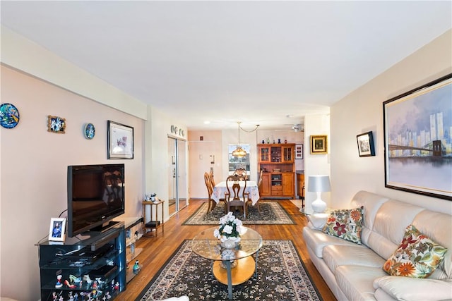 living room featuring light wood-type flooring and an inviting chandelier