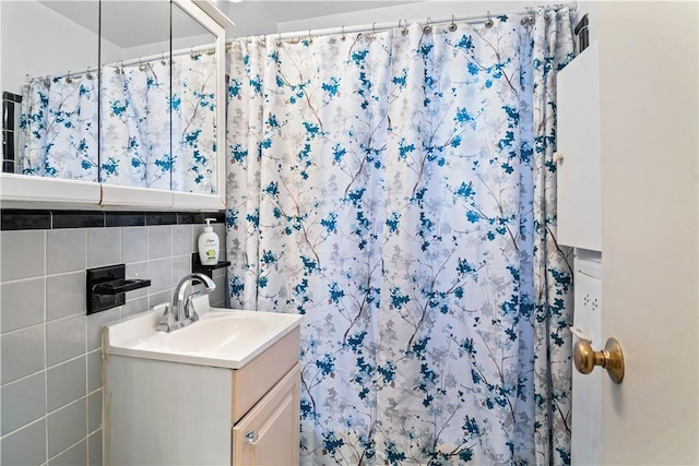 bathroom featuring a shower with curtain, vanity, and tile walls