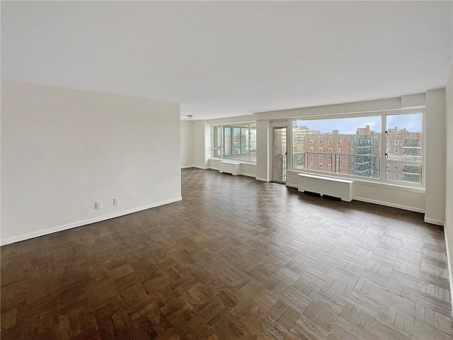 empty room featuring dark parquet floors