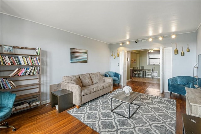 living room featuring ceiling fan and dark hardwood / wood-style floors