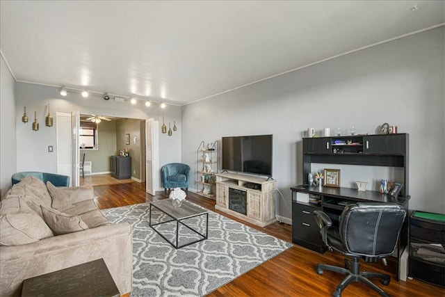 living room featuring ceiling fan, dark hardwood / wood-style flooring, and ornamental molding