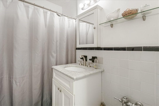 bathroom with vanity and tile walls