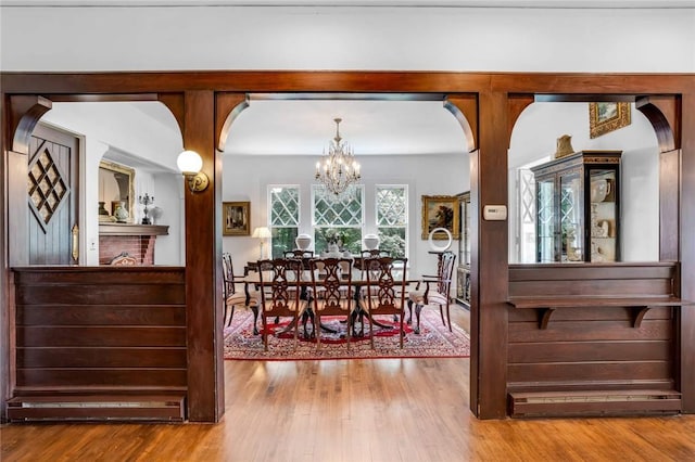 dining room with hardwood / wood-style floors and an inviting chandelier