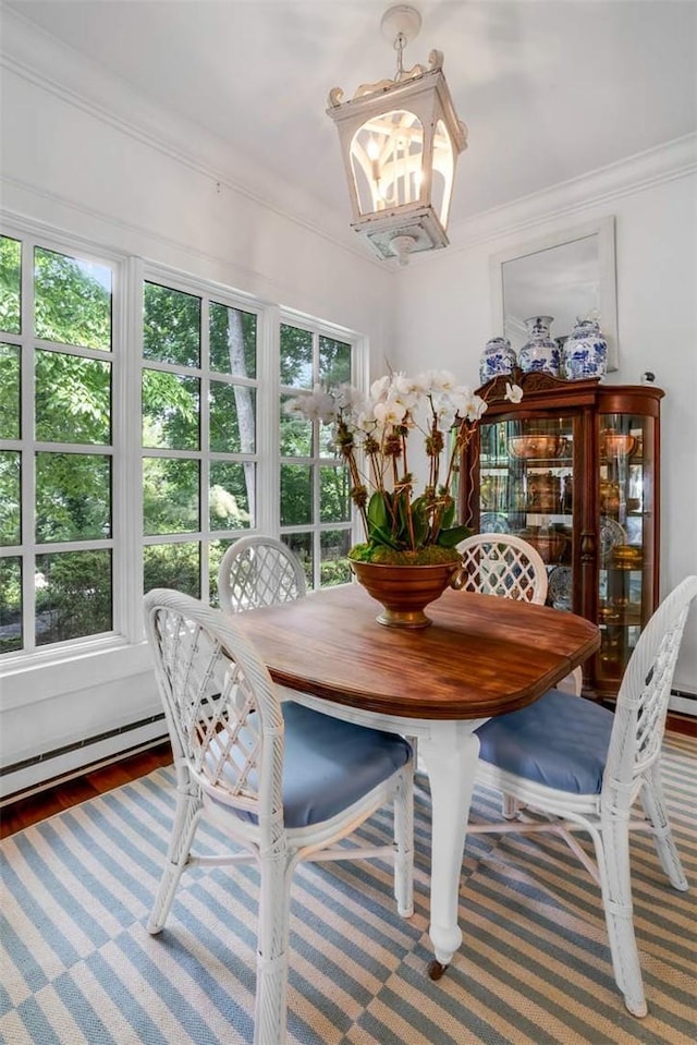 dining room featuring hardwood / wood-style floors, a notable chandelier, and crown molding