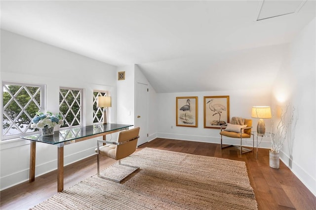 home office with wood-type flooring and vaulted ceiling