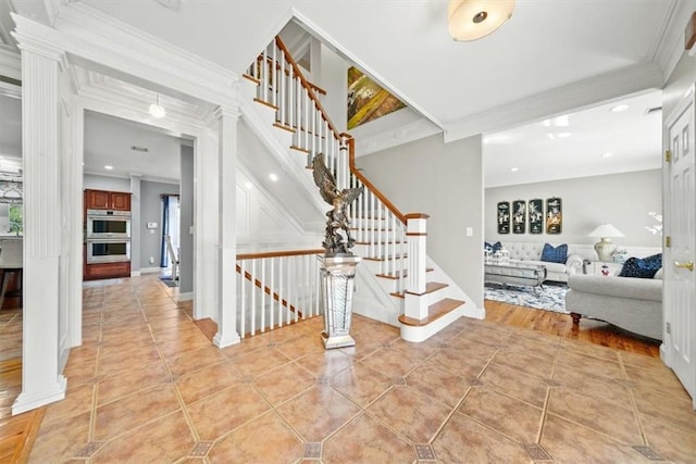 stairway with hardwood / wood-style floors and ornamental molding