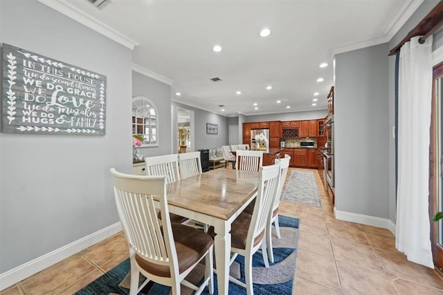 dining area featuring crown molding and light tile patterned floors