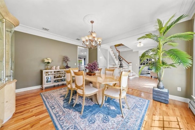 dining space with crown molding, an inviting chandelier, a baseboard radiator, and light wood-type flooring