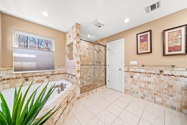 bathroom with tile patterned floors and shower with separate bathtub