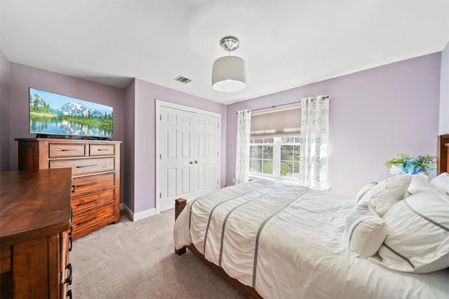 carpeted bedroom with a closet