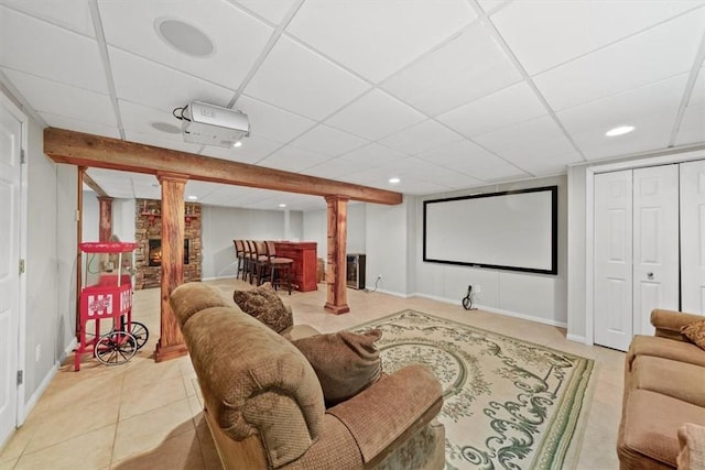 home theater room with tile patterned flooring and a drop ceiling