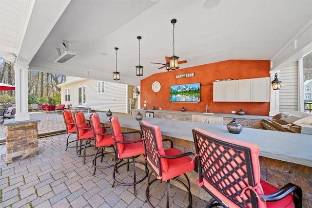 exterior space featuring ceiling fan and a wet bar