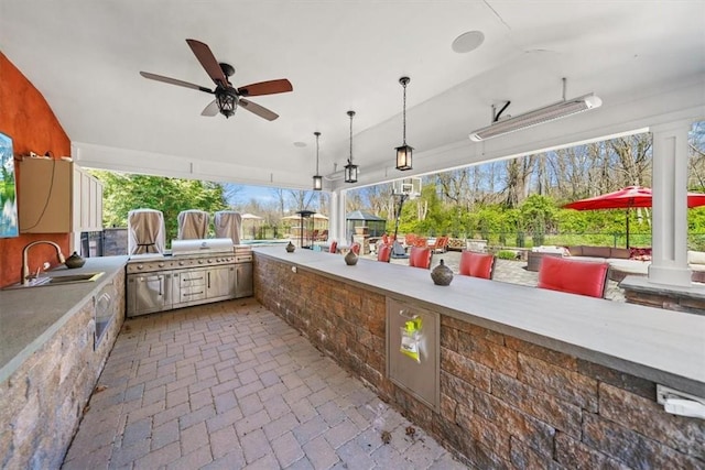 view of patio / terrace featuring an outdoor kitchen, grilling area, ceiling fan, and sink