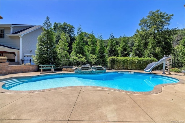 view of swimming pool featuring a patio area and a water slide