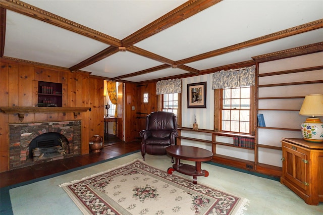 living room featuring beam ceiling, wood walls, and a fireplace