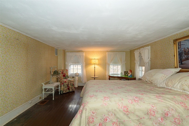 bedroom with dark hardwood / wood-style floors and ornamental molding