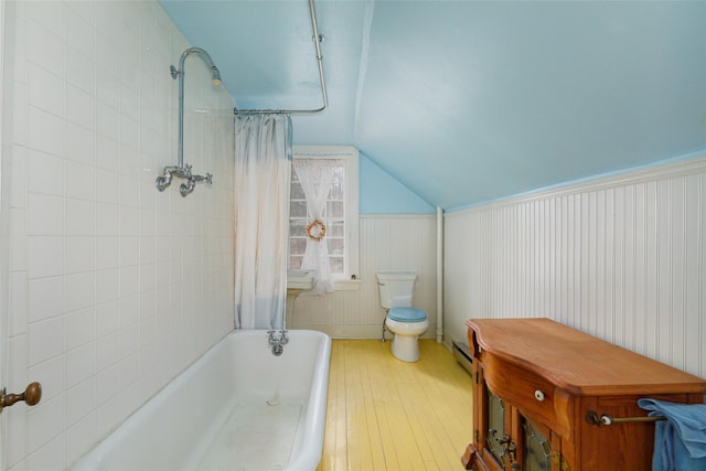 bathroom featuring toilet, shower / bath combo with shower curtain, a baseboard radiator, and vaulted ceiling