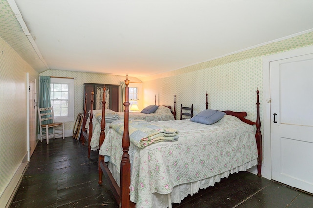 bedroom with dark hardwood / wood-style floors and crown molding