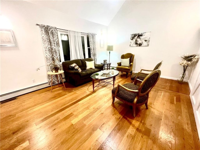 sitting room featuring a baseboard radiator, vaulted ceiling, and hardwood / wood-style flooring