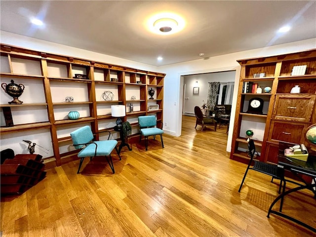 living area featuring light hardwood / wood-style floors and baseboard heating