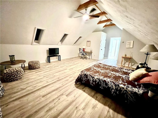 bedroom featuring ceiling fan, light wood-type flooring, and vaulted ceiling