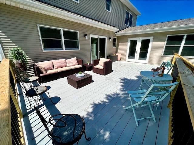 wooden deck with an outdoor hangout area and french doors