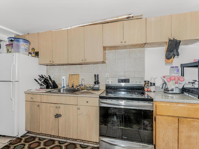 kitchen with light brown cabinets, white refrigerator, stainless steel electric range, and sink