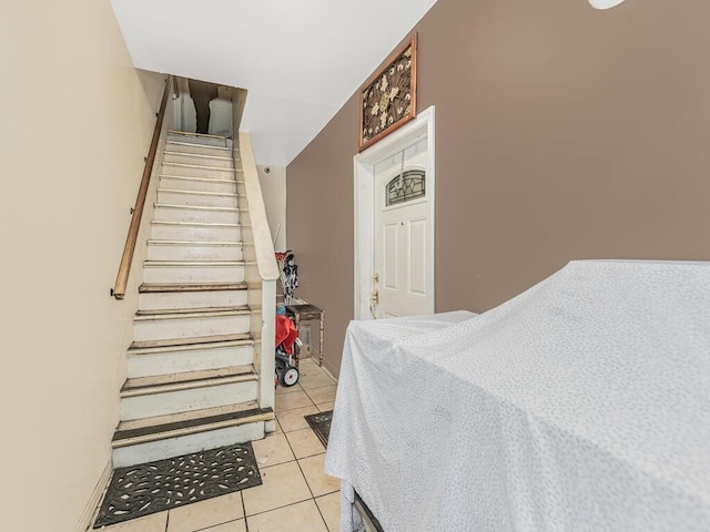 stairs featuring tile patterned flooring