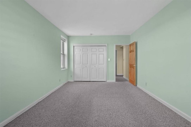 unfurnished bedroom with light carpet and a closet