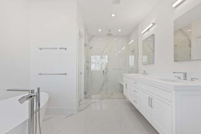 bathroom featuring a marble finish shower, double vanity, a freestanding tub, marble finish floor, and a sink