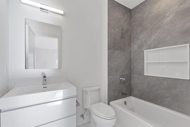 bathroom featuring toilet, vanity, and washtub / shower combination