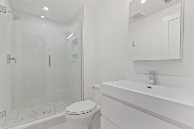 full bathroom with visible vents, a shower stall, toilet, and vanity