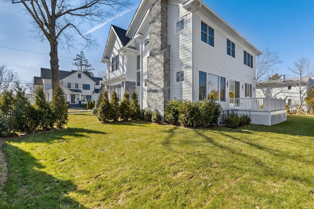 view of home's exterior with a yard and a wooden deck