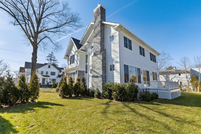 view of home's exterior with a yard and a chimney