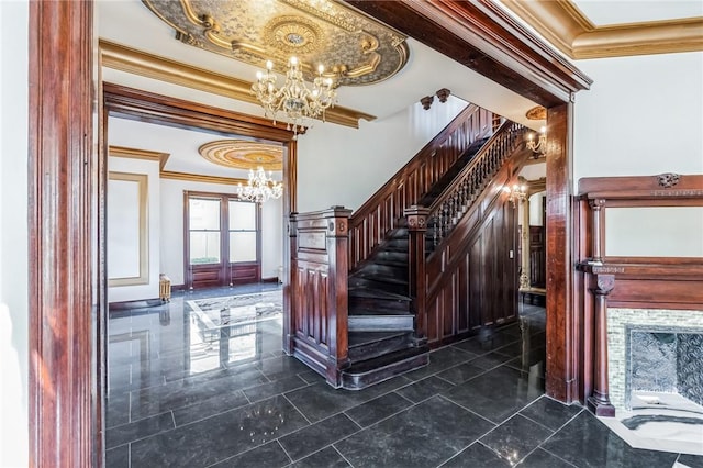 staircase with french doors, an inviting chandelier, and ornamental molding