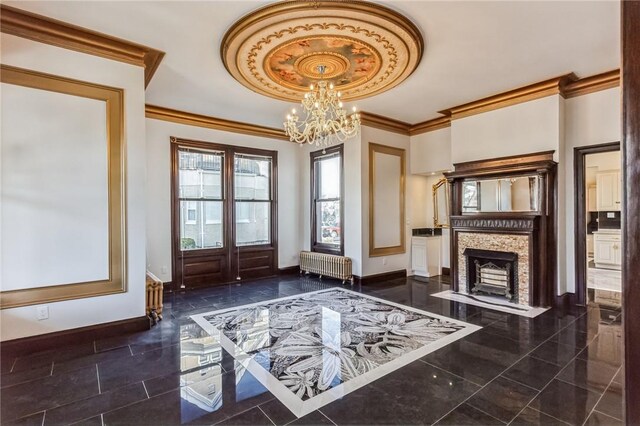 doorway to outside with radiator, french doors, ornamental molding, and a notable chandelier