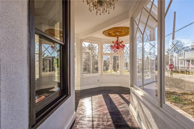 unfurnished sunroom with a chandelier