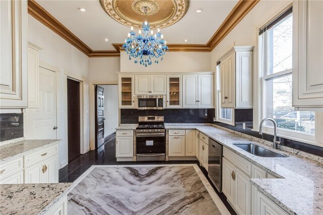 kitchen featuring pendant lighting, plenty of natural light, sink, and stainless steel appliances