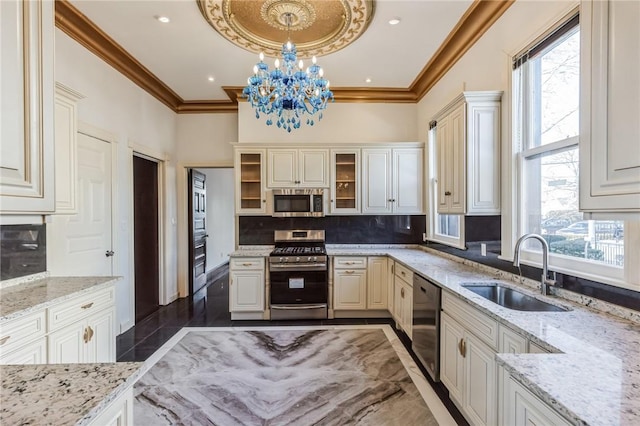 101 Summit Ave, Mount Vernon, NY 10550 - kitchen featuring stainless steel appliances, a sink, a chandelier, tasteful backsplash, and crown molding