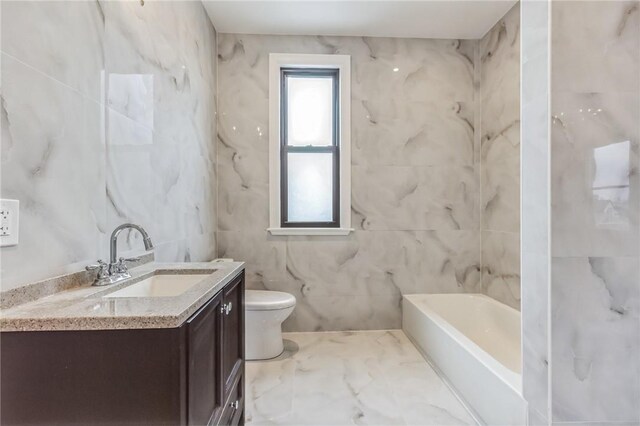 bathroom featuring vanity, tile walls, and toilet