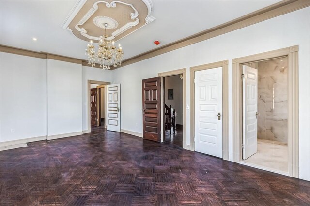 unfurnished bedroom featuring dark parquet flooring, connected bathroom, and a chandelier