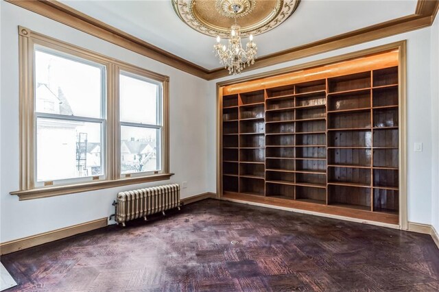 unfurnished room with radiator, crown molding, dark parquet floors, and an inviting chandelier