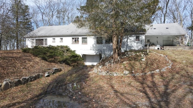 rear view of house with a garage