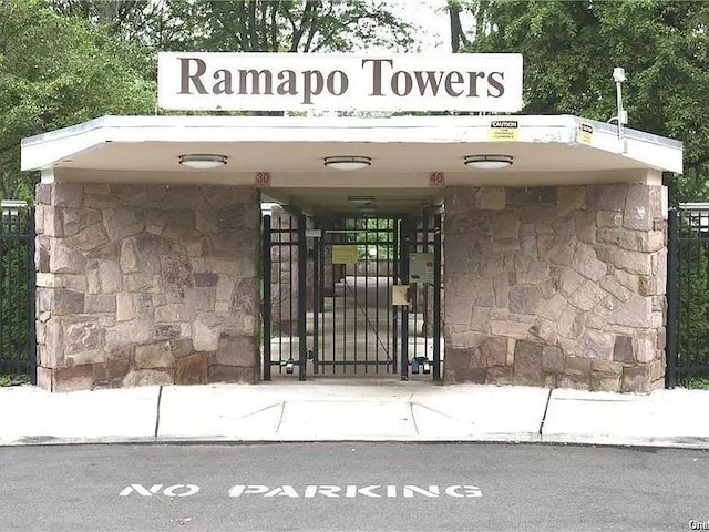 30 S Cole Ave Unit 3E, Spring Valley, NY 10977 - doorway to property featuring stone siding and a gate