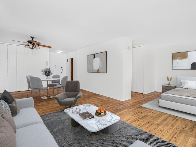 living room with hardwood / wood-style flooring and ceiling fan